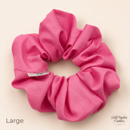 Large pink cotton scrunchie with gathered fabric and brand tag