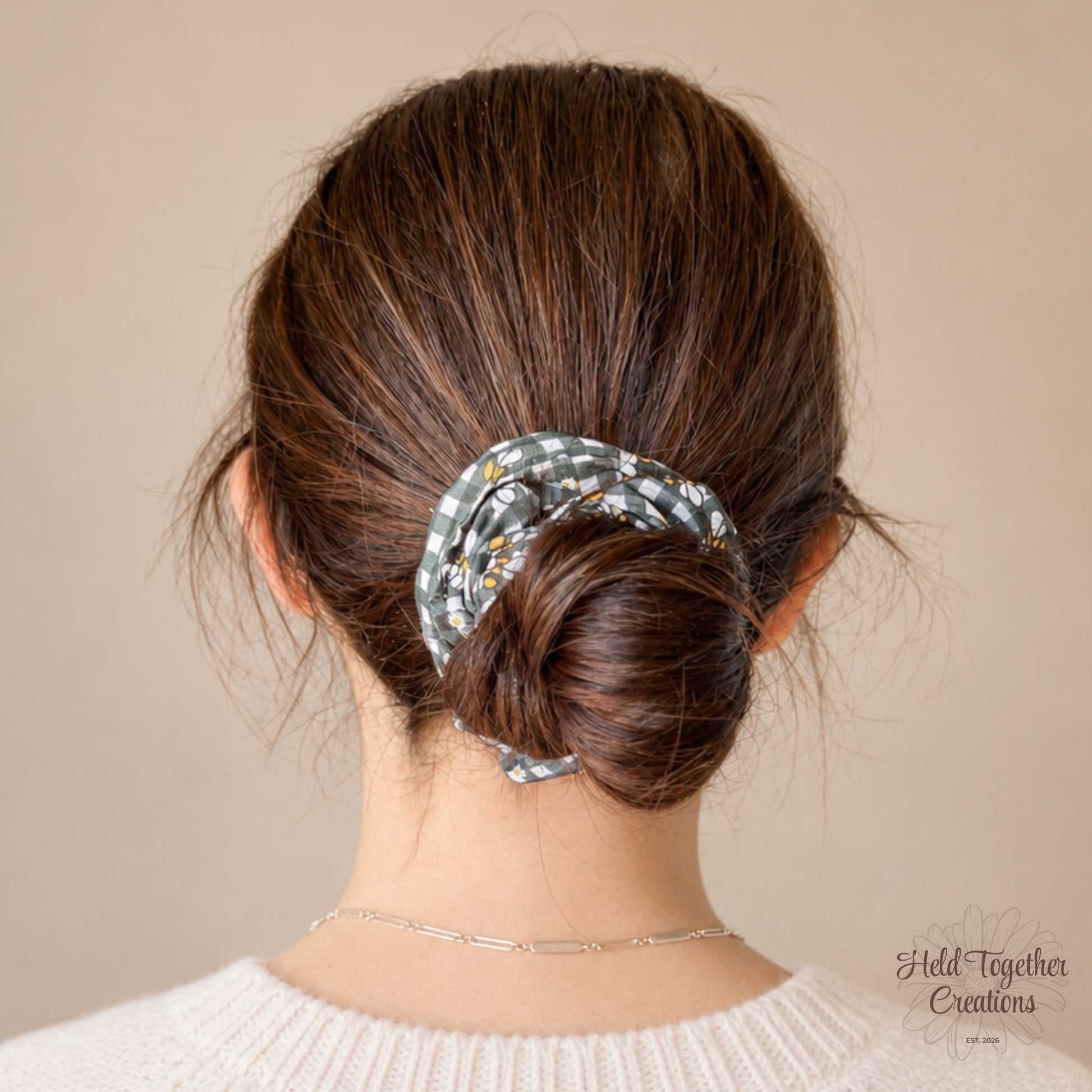 Black and white checkered scrunchie with bee pattern on a beige background