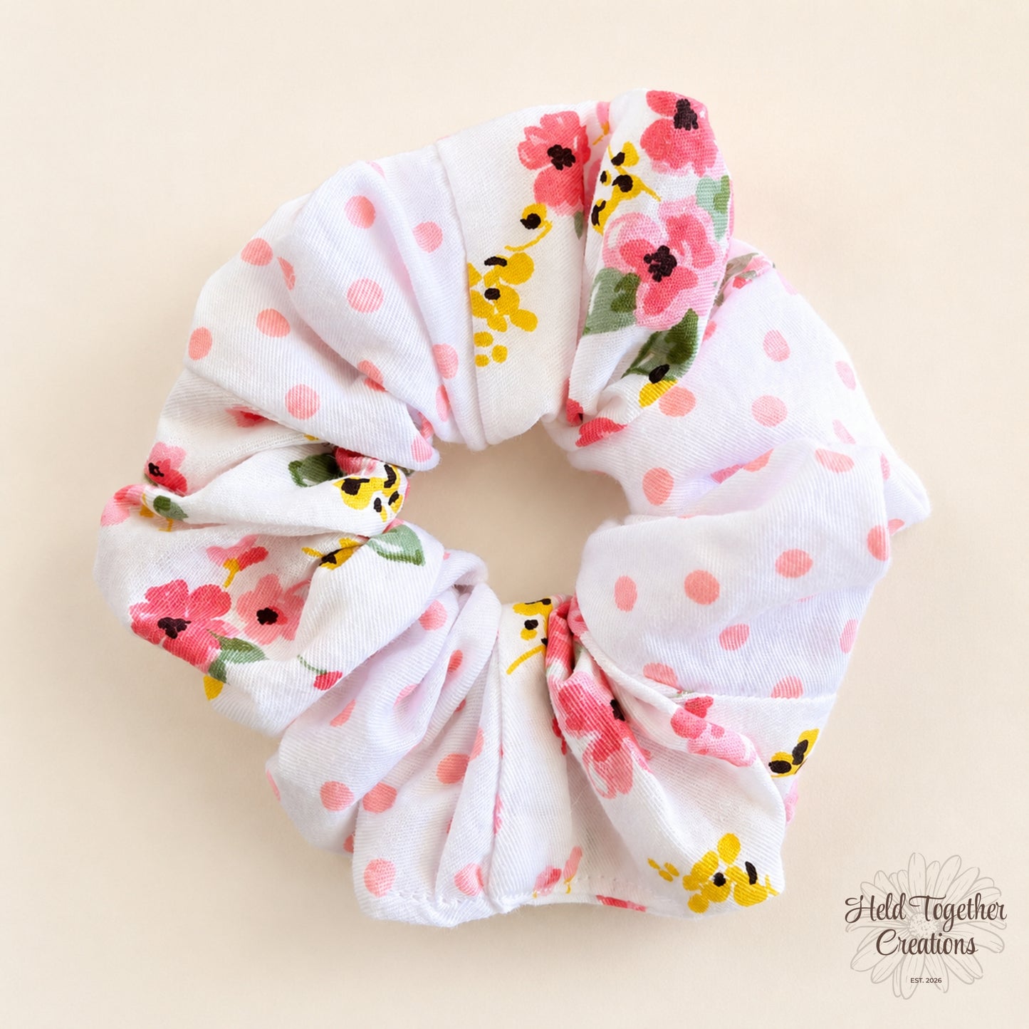 Blossom Spot handmade scrunchie with pink spots and colourful floral print on white fabric.