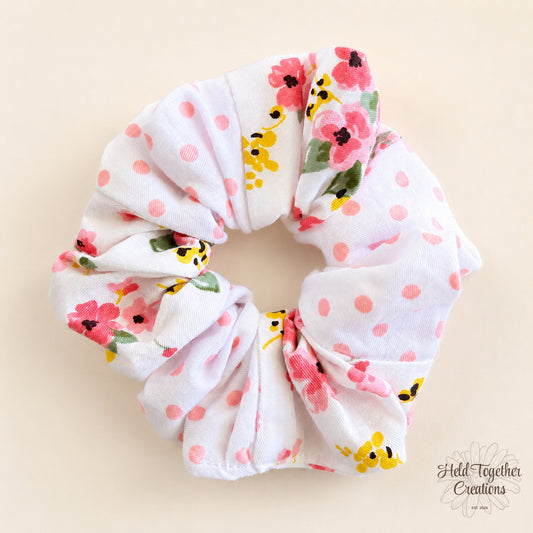 Blossom Spot handmade scrunchie with pink spots and colourful floral print on white fabric.