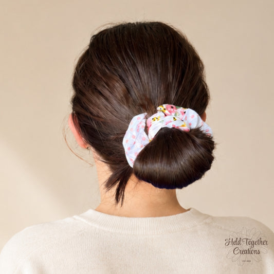 Blossom Spot handmade scrunchie with pink spots and colourful floral print on white fabric.