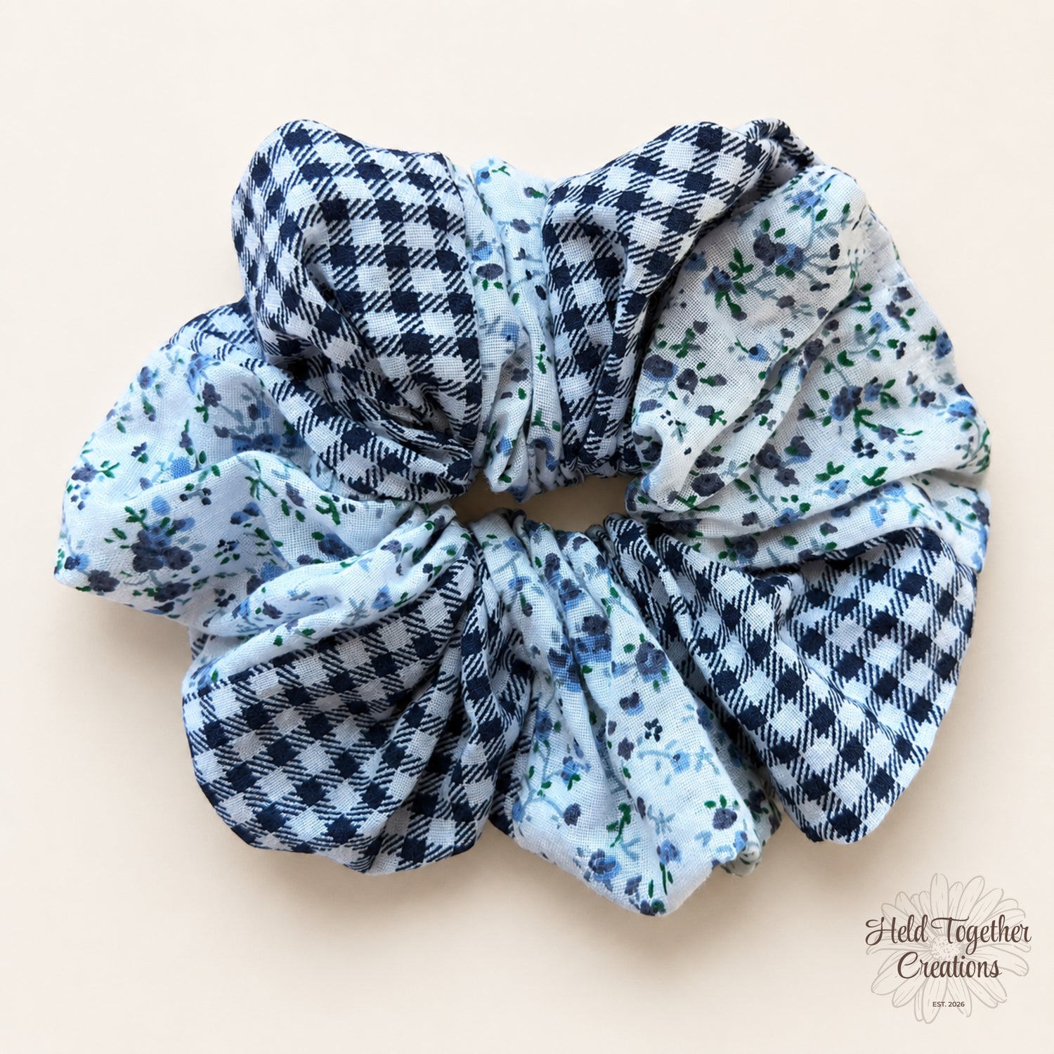 Handmade Checked Bloom Scrunchie with blue floral fabric and navy check fabric on a warm ivory background.