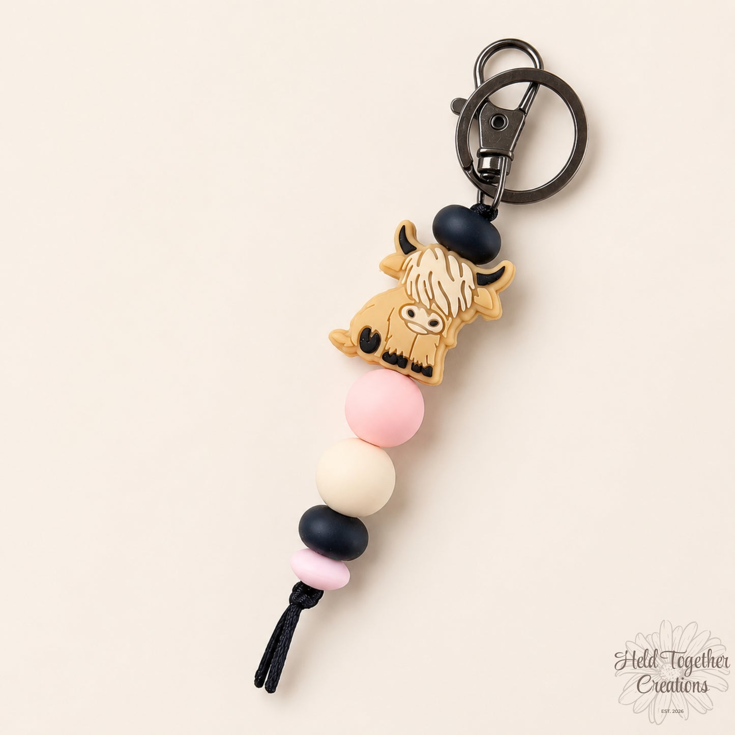Handmade highland cow silicone bead keyrings with soft silicone beads and black keyring hardware on a neutral background.