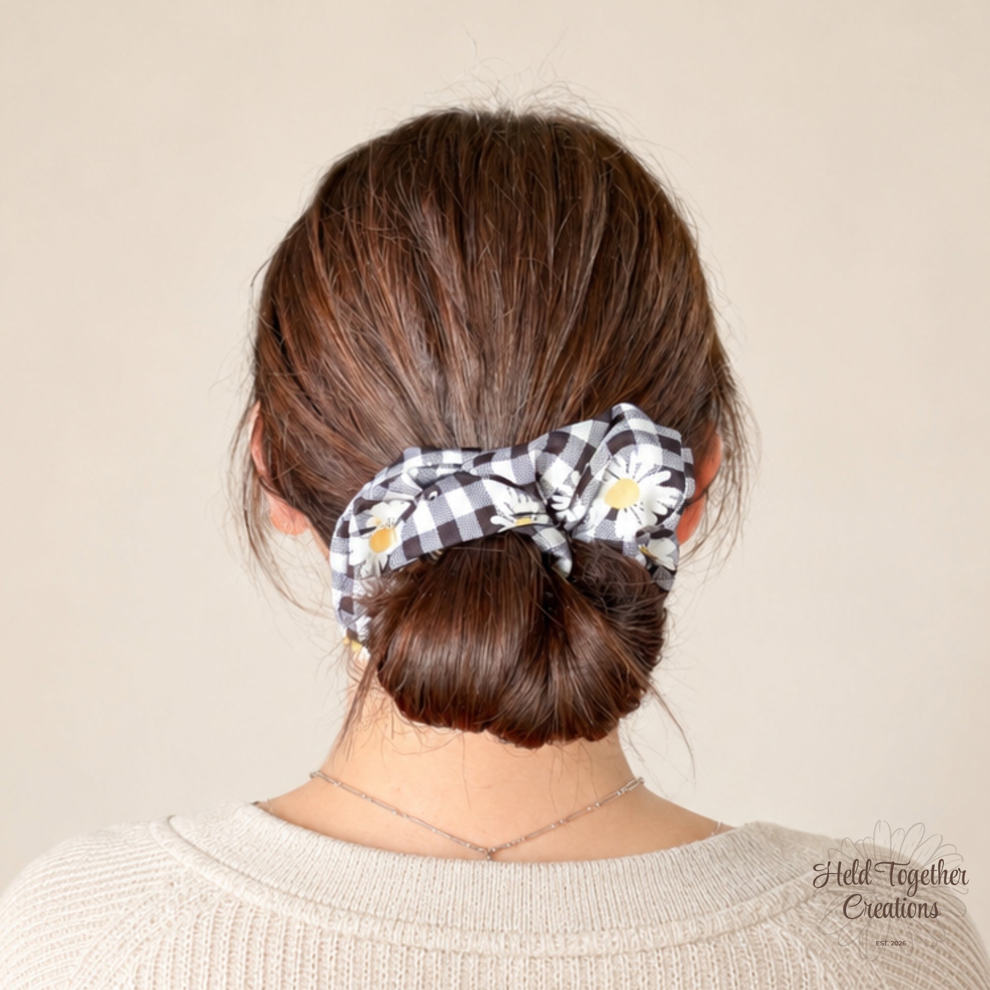 Handmade Daisy Check Scrunchie with black and white check fabric, white daisy print and yellow flower centres on a soft ivory background.