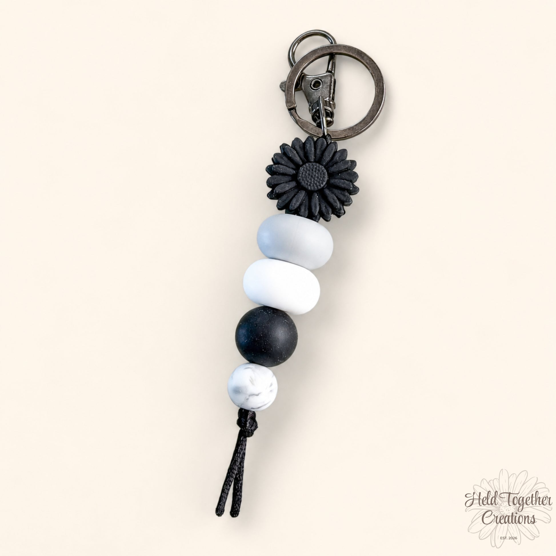 Daisy Pop handmade silicone bead keyrings in pink and black with daisy flower beads and metal keyring hardware.