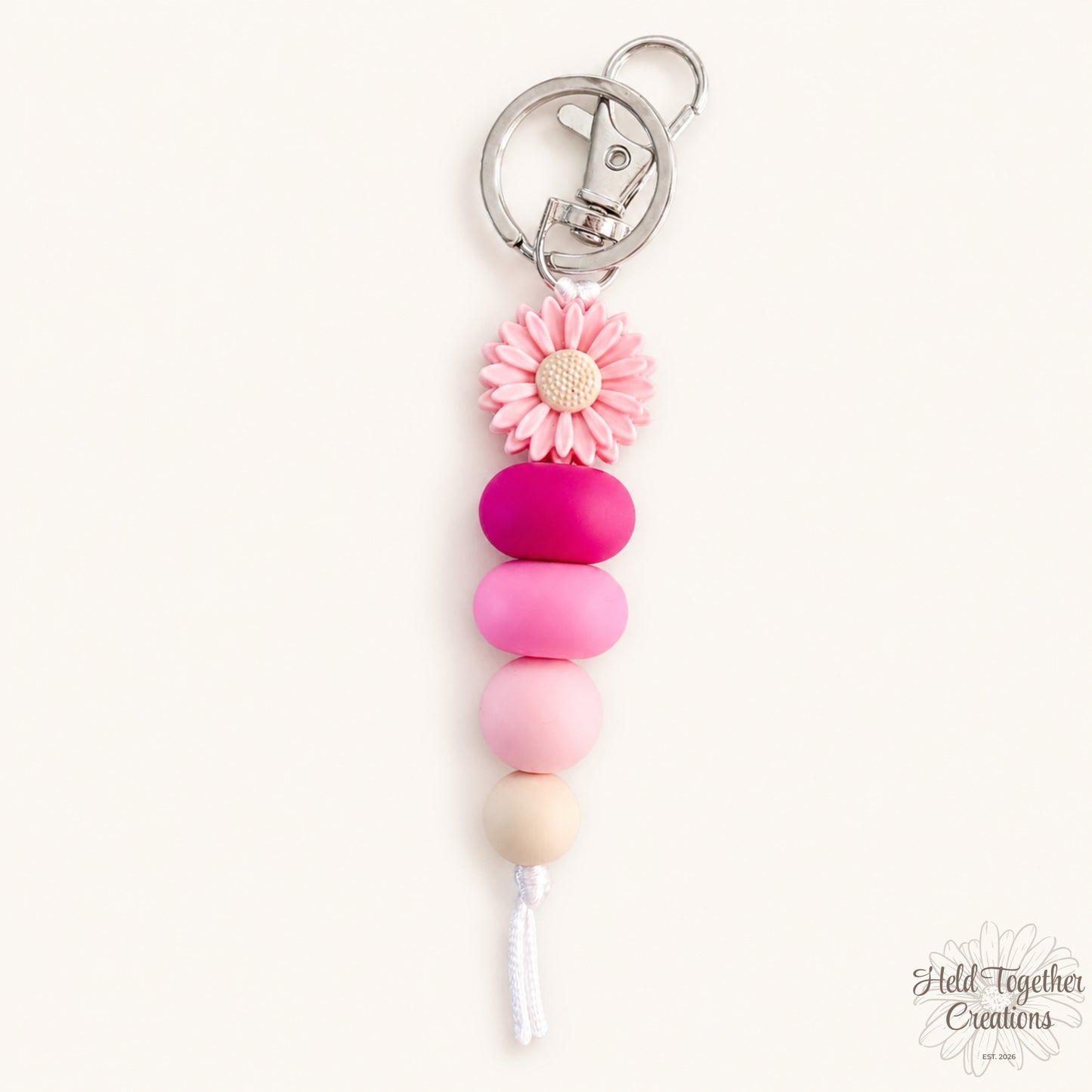 Daisy Pop handmade silicone bead keyrings in pink and black with daisy flower beads and metal keyring hardware.