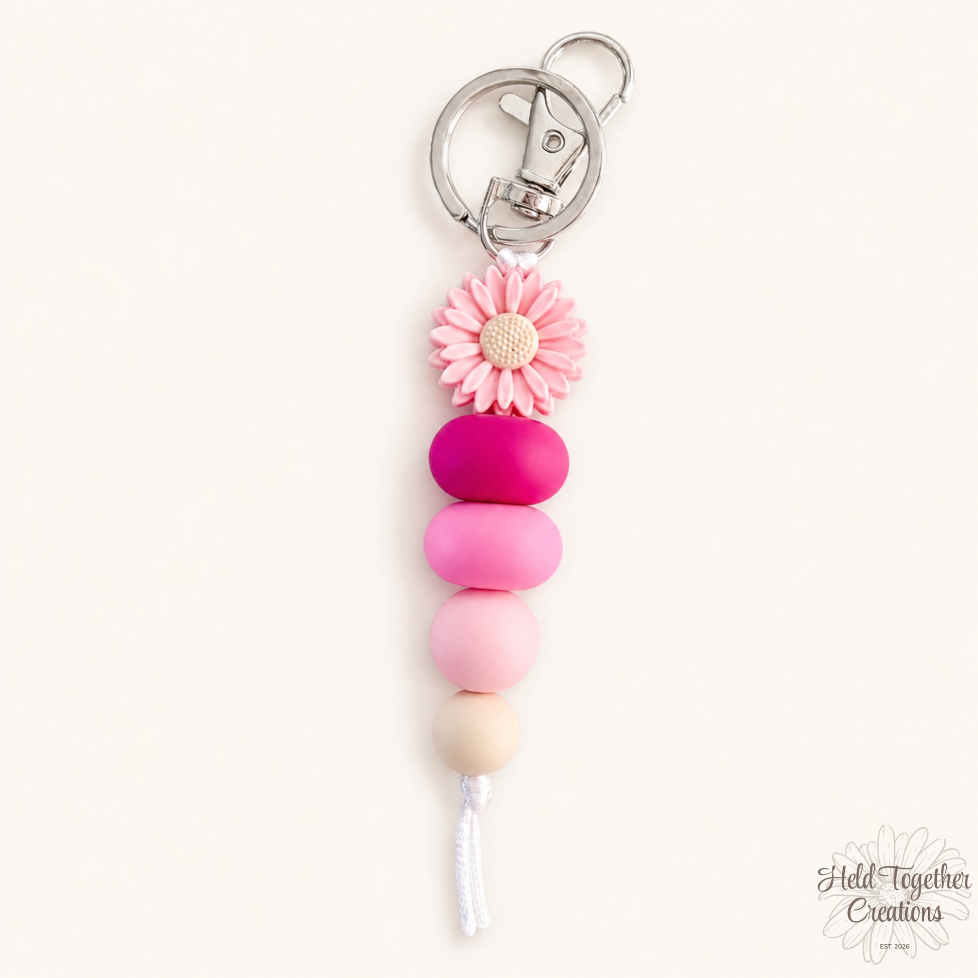 Daisy Pop handmade silicone bead keyrings in pink and black with daisy flower beads and metal keyring hardware.