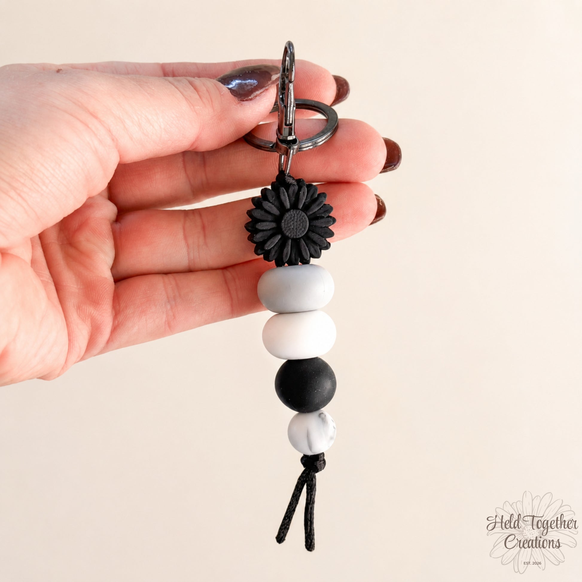 Daisy Pop handmade silicone bead keyrings in pink and black with daisy flower beads and metal keyring hardware.