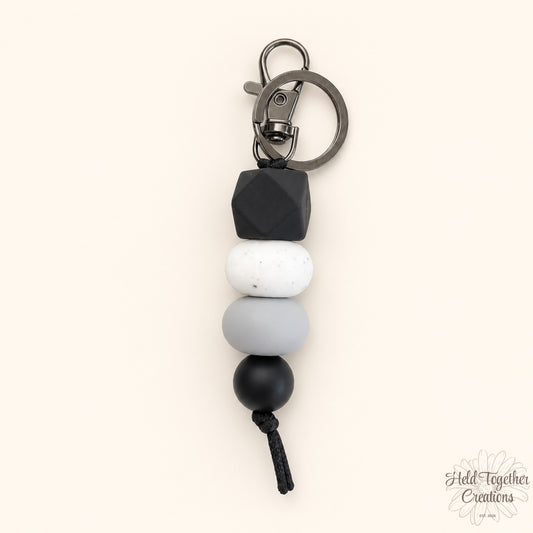 Dark and Stormy handmade silicone bead keyrings in black, grey, white and speckled beads with metal keyring hardware.