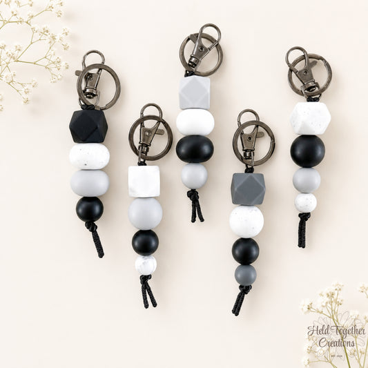 Dark and Stormy handmade silicone bead keyrings in black, grey, white and speckled beads with metal keyring hardware.