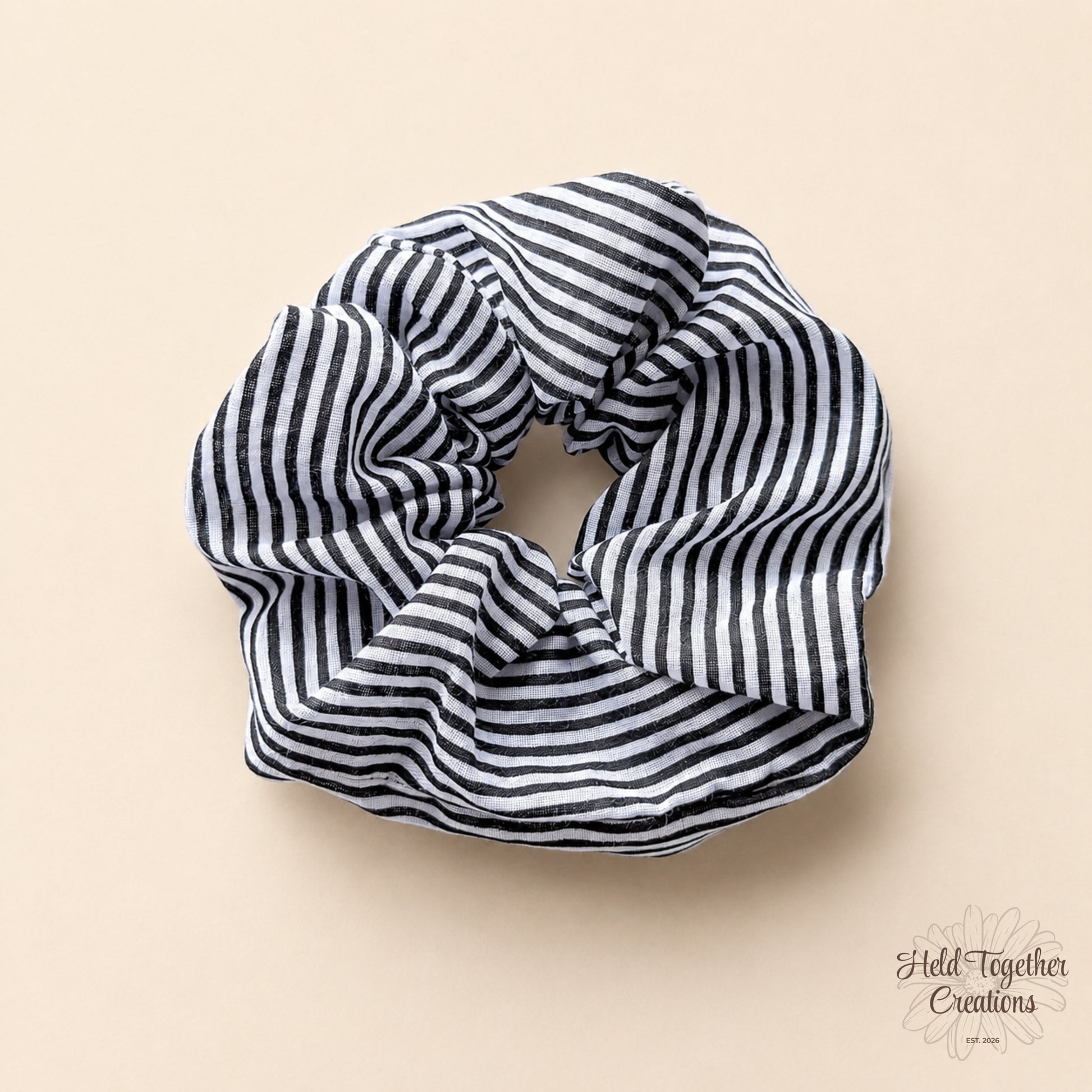 Black and white striped scrunchie on a beige background
