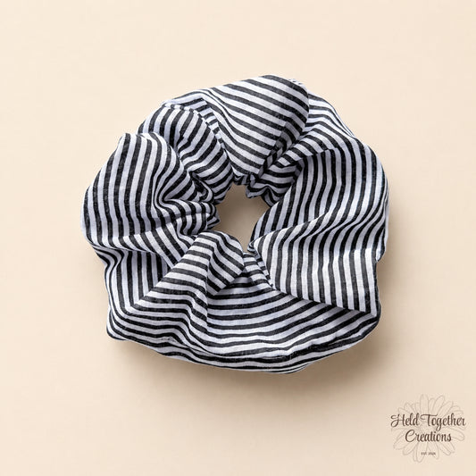 Black and white striped scrunchie on a beige background