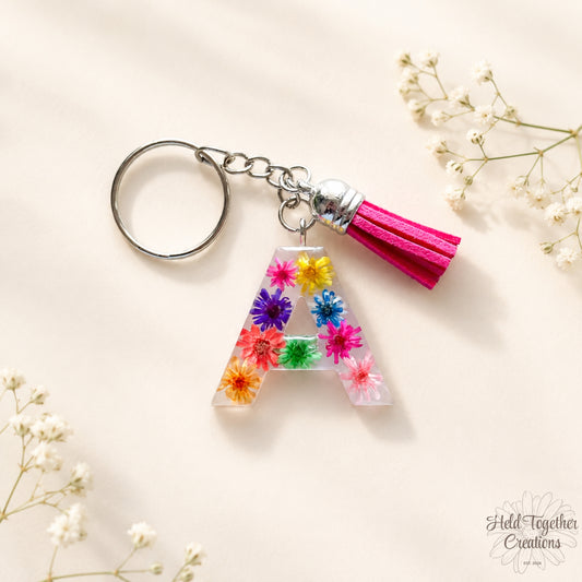 Keychain with floral letter 'A' and tassel on a light background