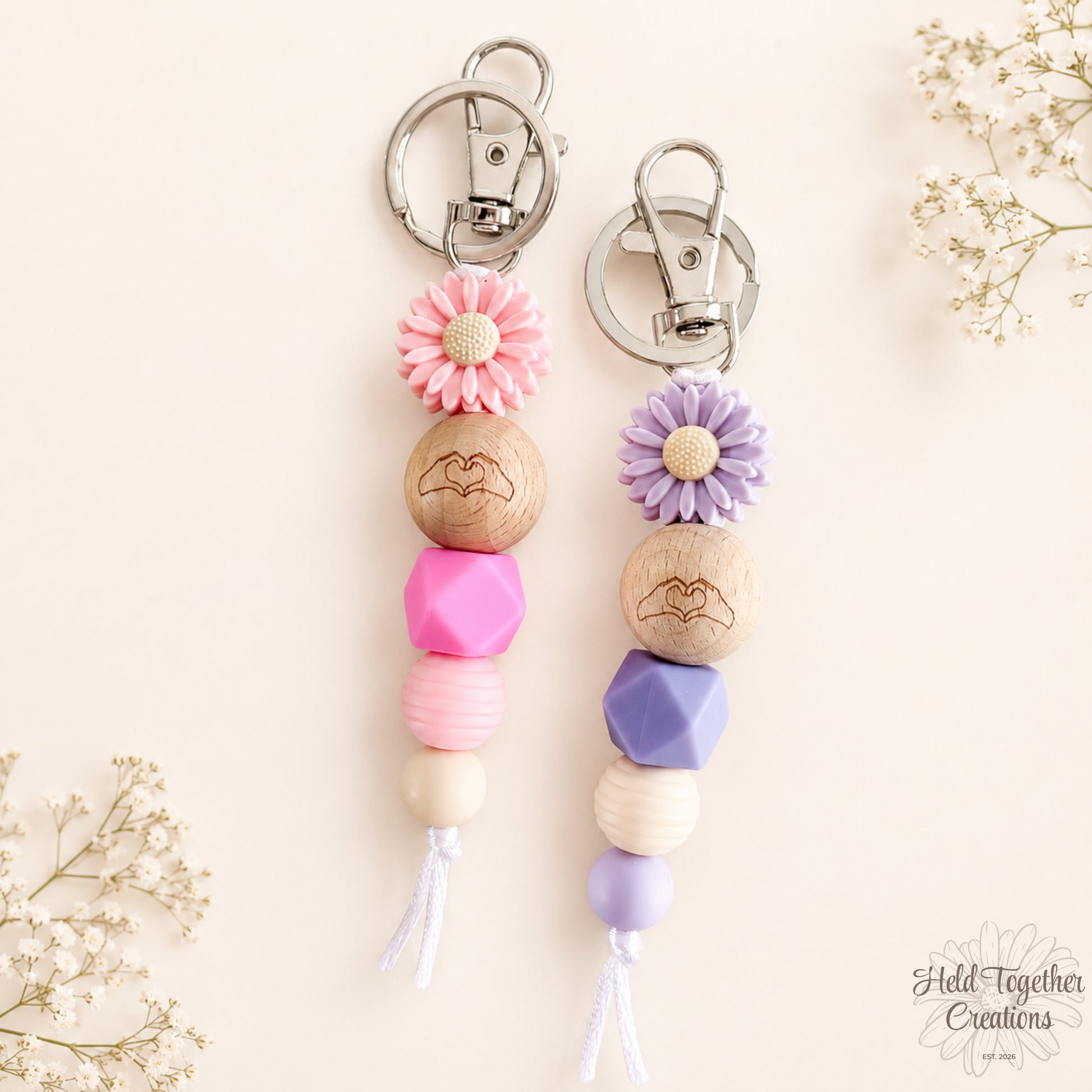 Pink and purple handmade Heart Hands silicone bead keyrings with daisy beads and silver keyring hardware.