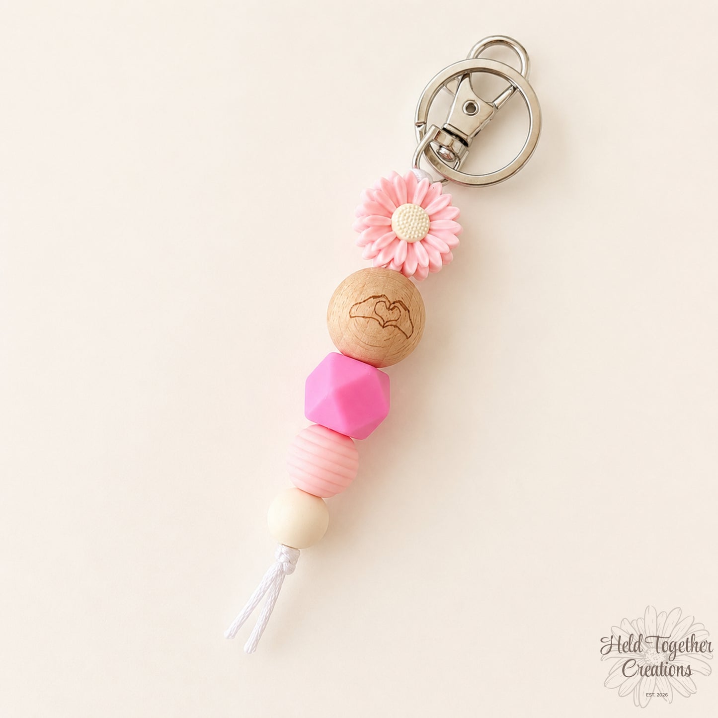 Pink and purple handmade Heart Hands silicone bead keyrings with daisy beads and silver keyring hardware.
