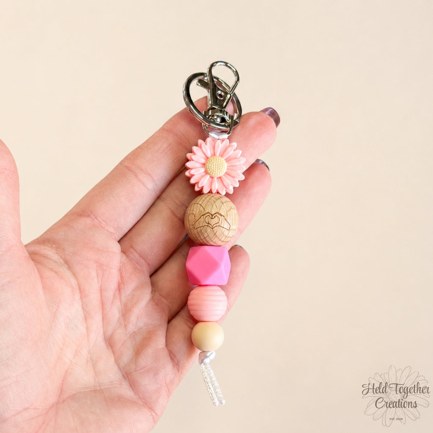 Pink and purple handmade Heart Hands silicone bead keyrings with daisy beads and silver keyring hardware.