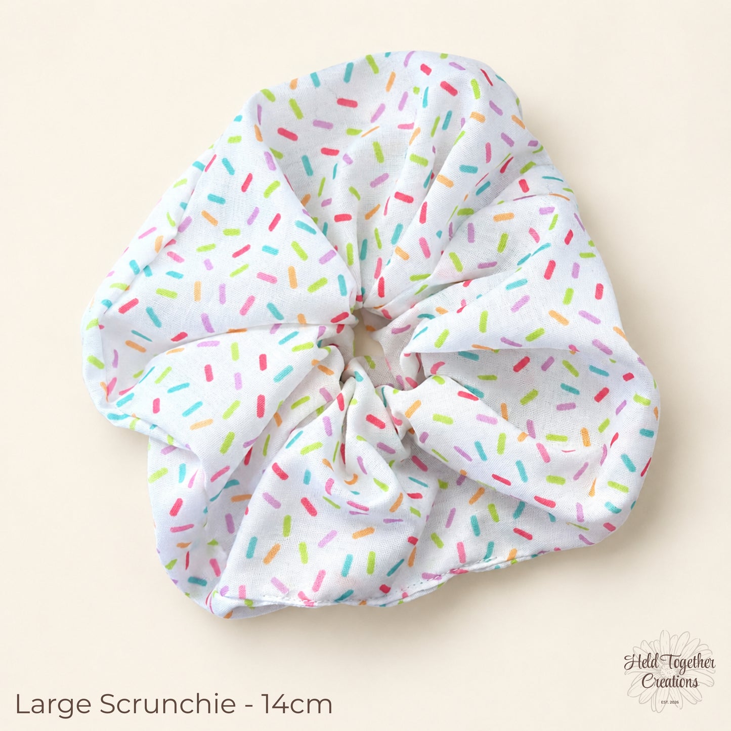 Large Rainbow Sprinkle Scrunchie on warm ivory background showing colourful sprinkle print