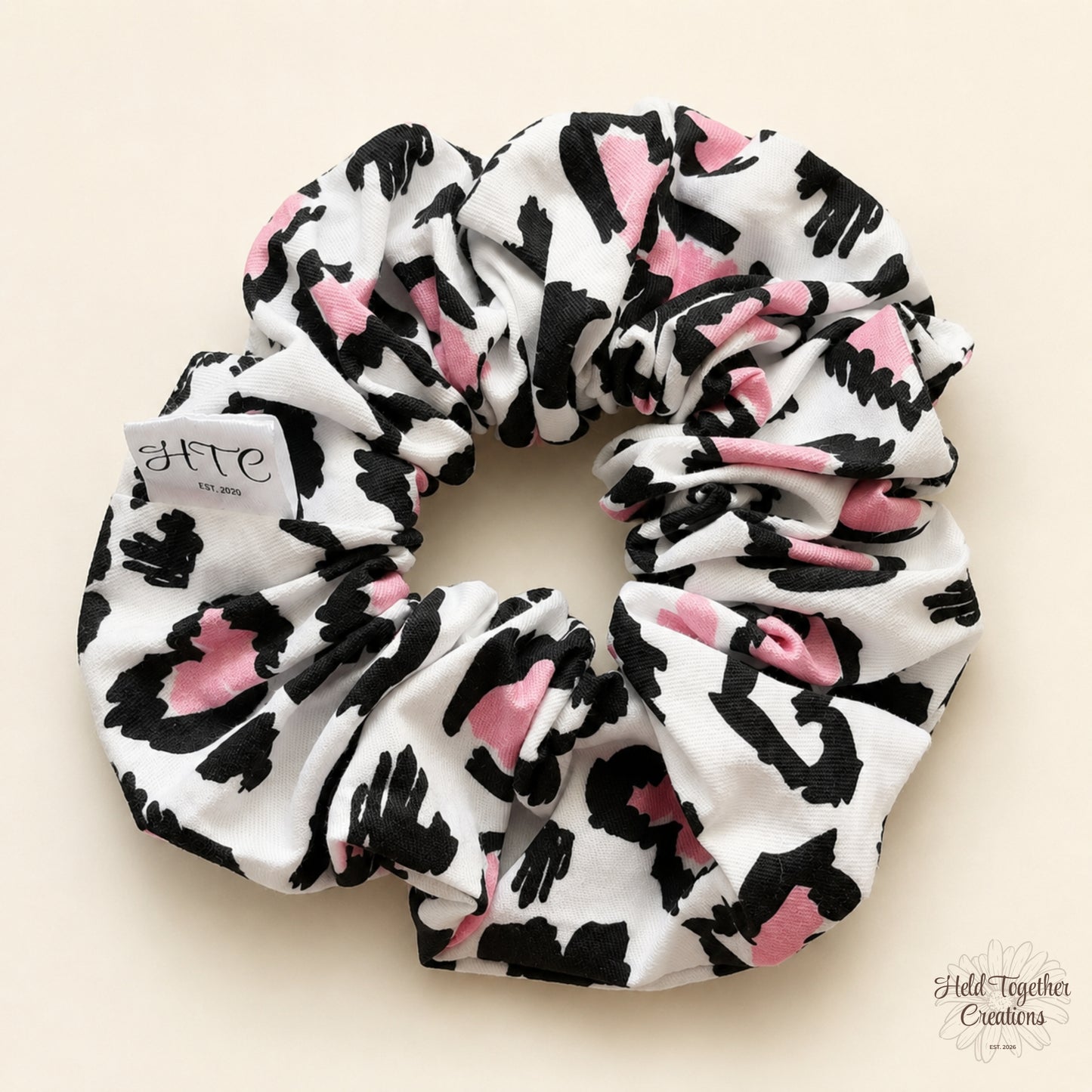Handmade Leopard Love Scrunchie with black, white and pink leopard-inspired print on a soft neutral background.