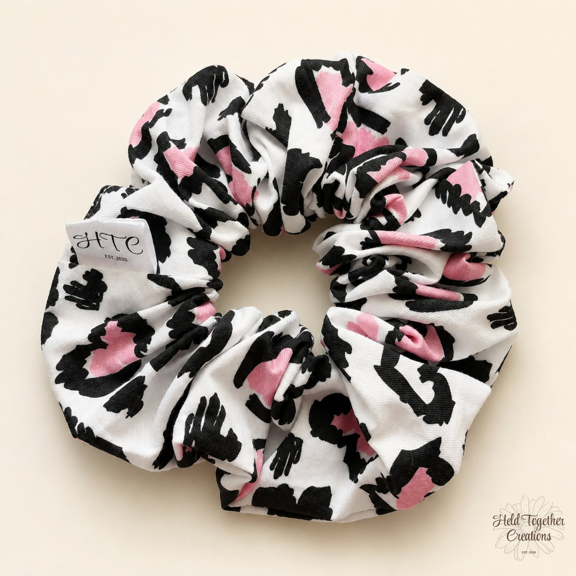 Handmade Leopard Love Scrunchie with black, white and pink leopard-inspired print on a soft neutral background.