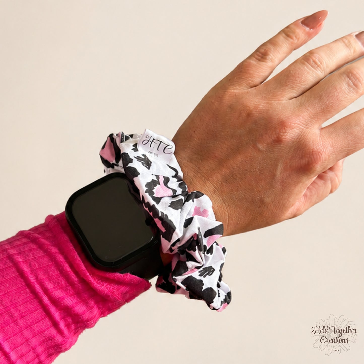 Leopard Love Scrunchie worn on the wrist beside an Apple Watch, showing size and everyday styling.
