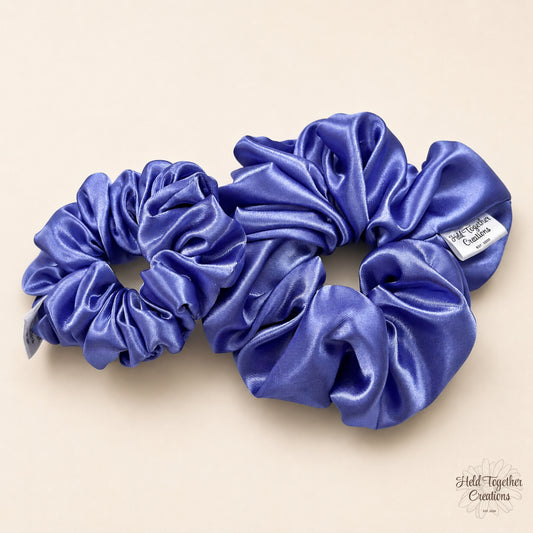 Small and large lilac satin scrunchies side by side showing size comparison.