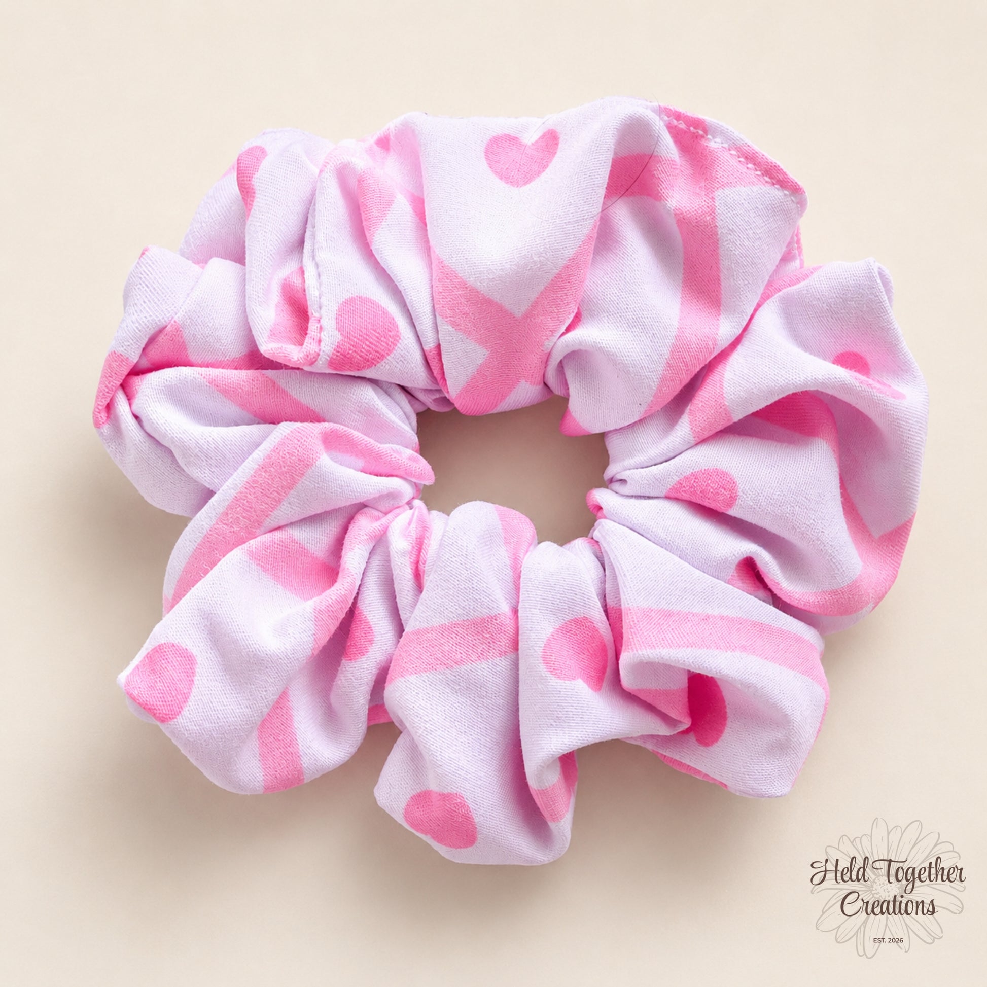 Handmade pink Love Notes Scrunchie with bright pink heart and scribble-style pattern on a soft ivory background.