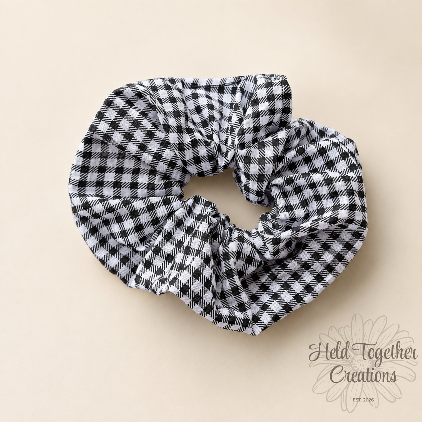 Black and white checkered scrunchie on a beige background