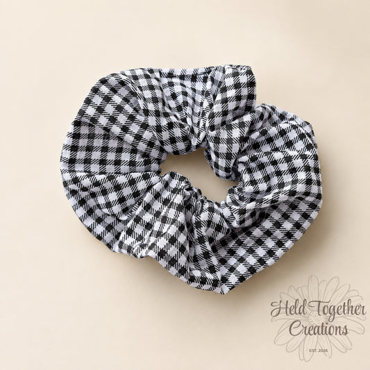 Black and white checkered scrunchie on a beige background