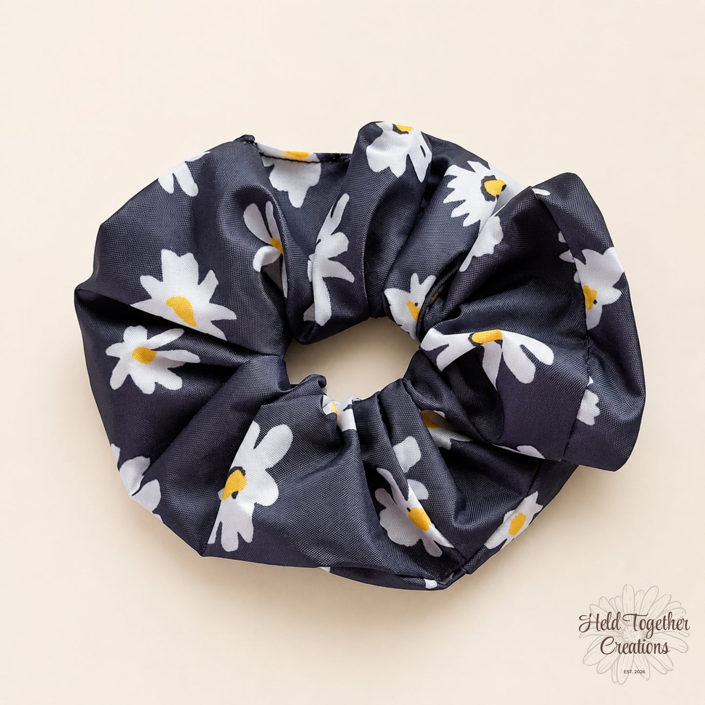 Moonlit Daisy Scrunchie with black fabric and white daisy floral print, handmade by Held Together Creations.