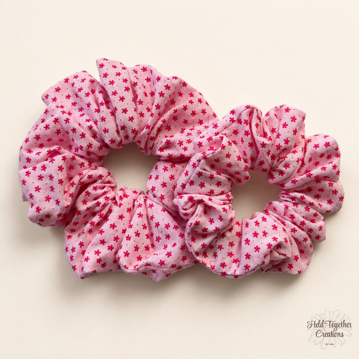 Small and large Petal Sprinkle Scrunchies laid side by side on a warm ivory background for size comparison.