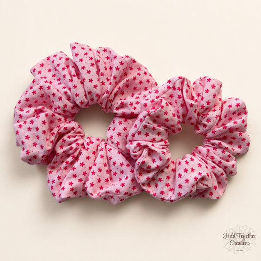 Small and large Petal Sprinkle Scrunchies laid side by side on a warm ivory background for size comparison.