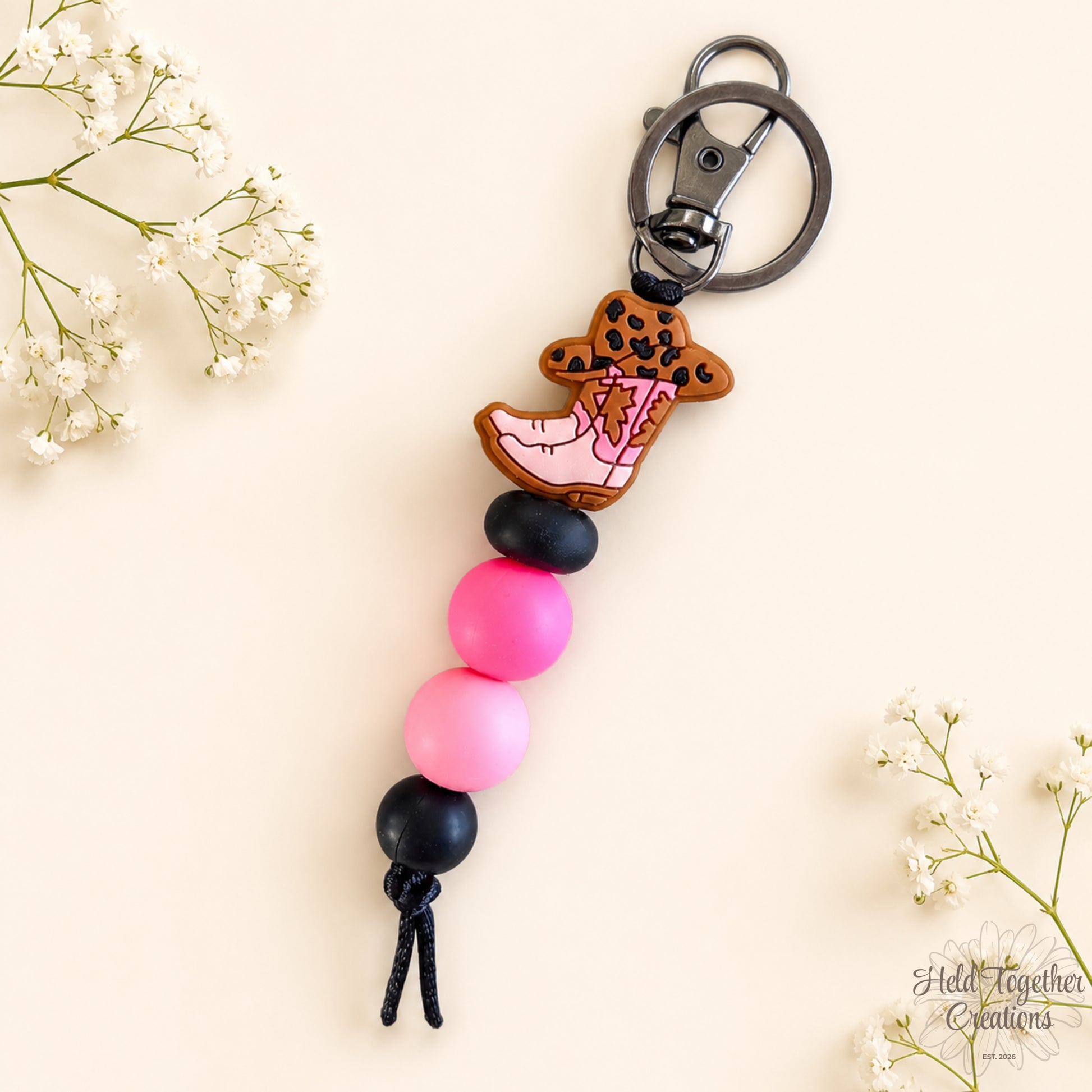 Handmade cowgirl boot silicone bead keyring with pink and black beads, metal keyring hardware and western boot charm.