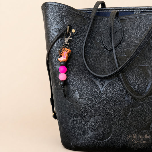 Handmade cowgirl boot silicone bead keyring with pink and black beads, metal keyring hardware and western boot charm.