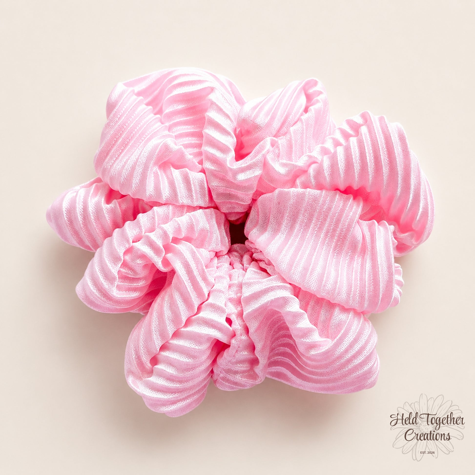Pink Fizz handmade scrunchie in bright pink textured satin-style fabric on a soft neutral background.