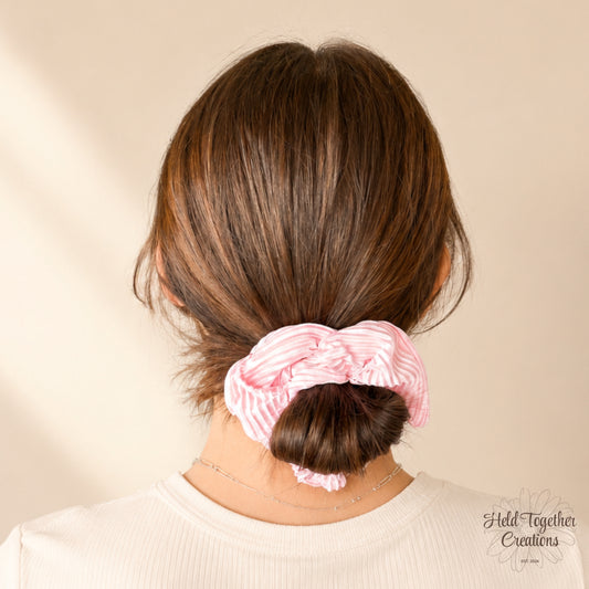 Pink Fizz handmade scrunchie in bright pink textured satin-style fabric on a soft neutral background.