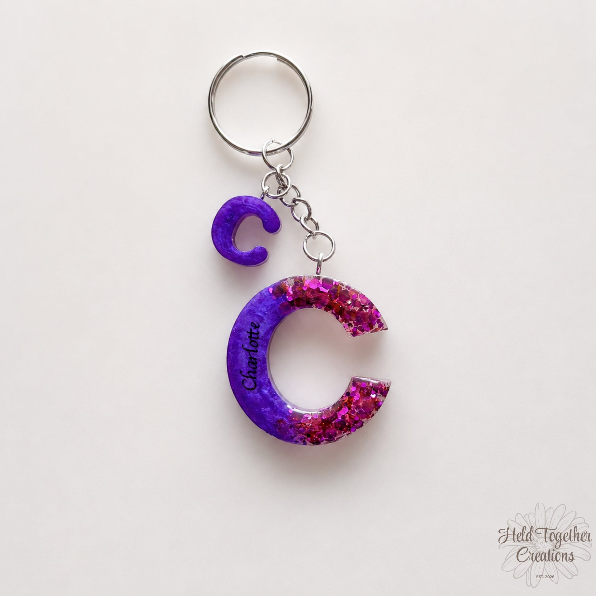 Keychain with a purple and pink letter 'C' on a white background