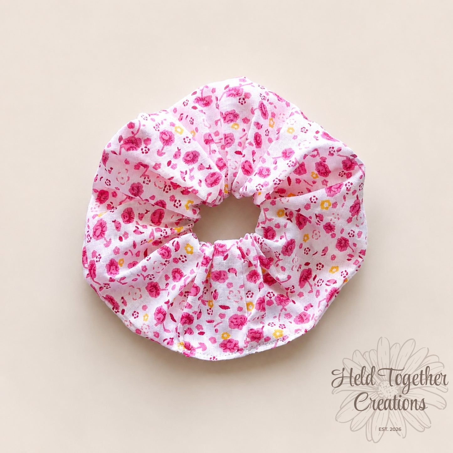 Handmade Rose Confetti scrunchie with pink floral print on white fabric.