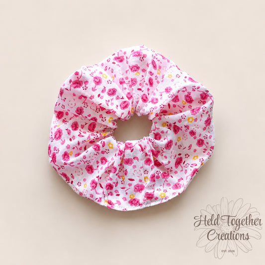 Handmade Rose Confetti scrunchie with pink floral print on white fabric.