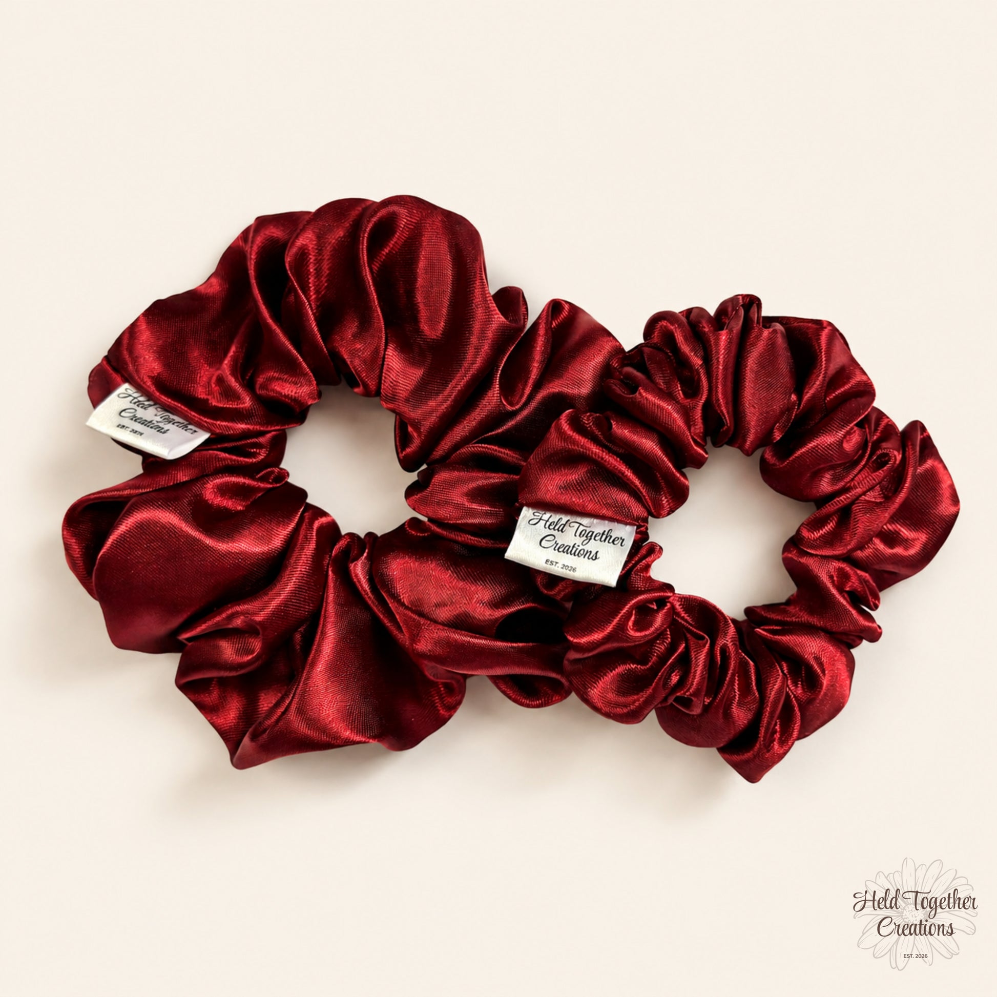 Small and large ruby satin scrunchies displayed together
