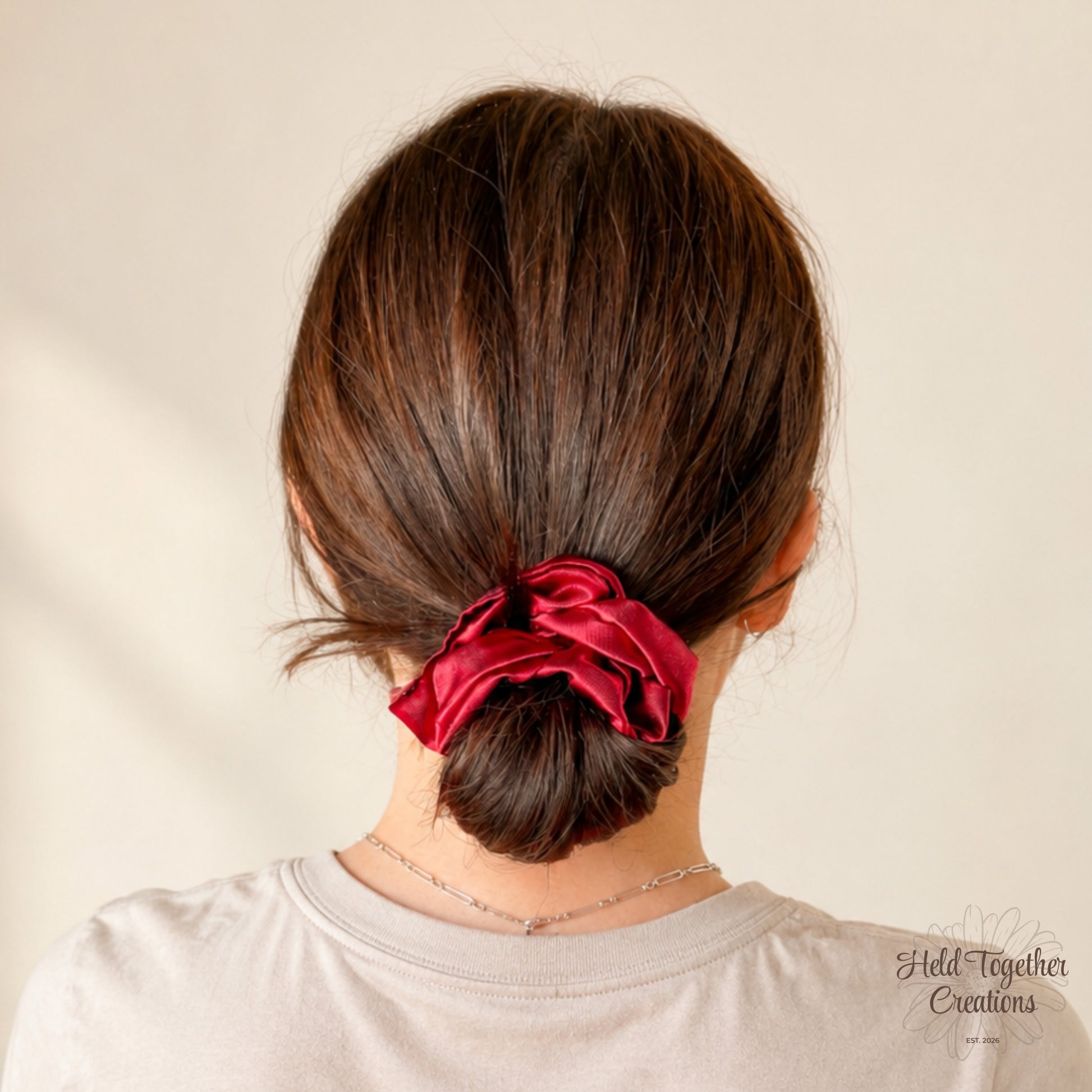 Ruby red satin scrunchie with a glossy finish, handmade by Held Together Creations.