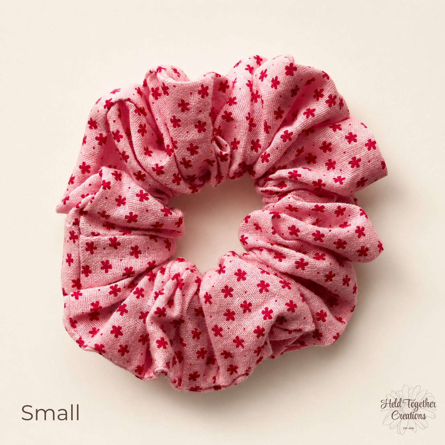 Small Petal Sprinkle Scrunchie laid flat on a warm ivory background showing the mini floral pattern.