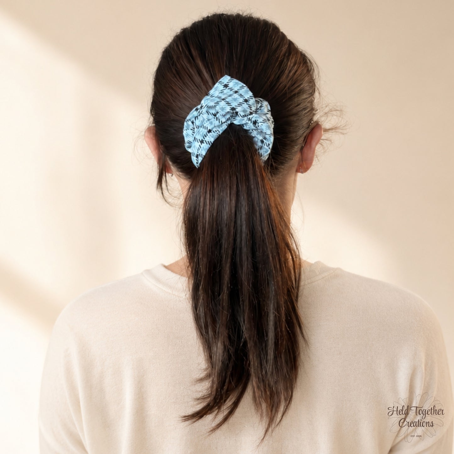 Urban Ash Scrunchie worn in a ponytail with black and grey checked fabric print.